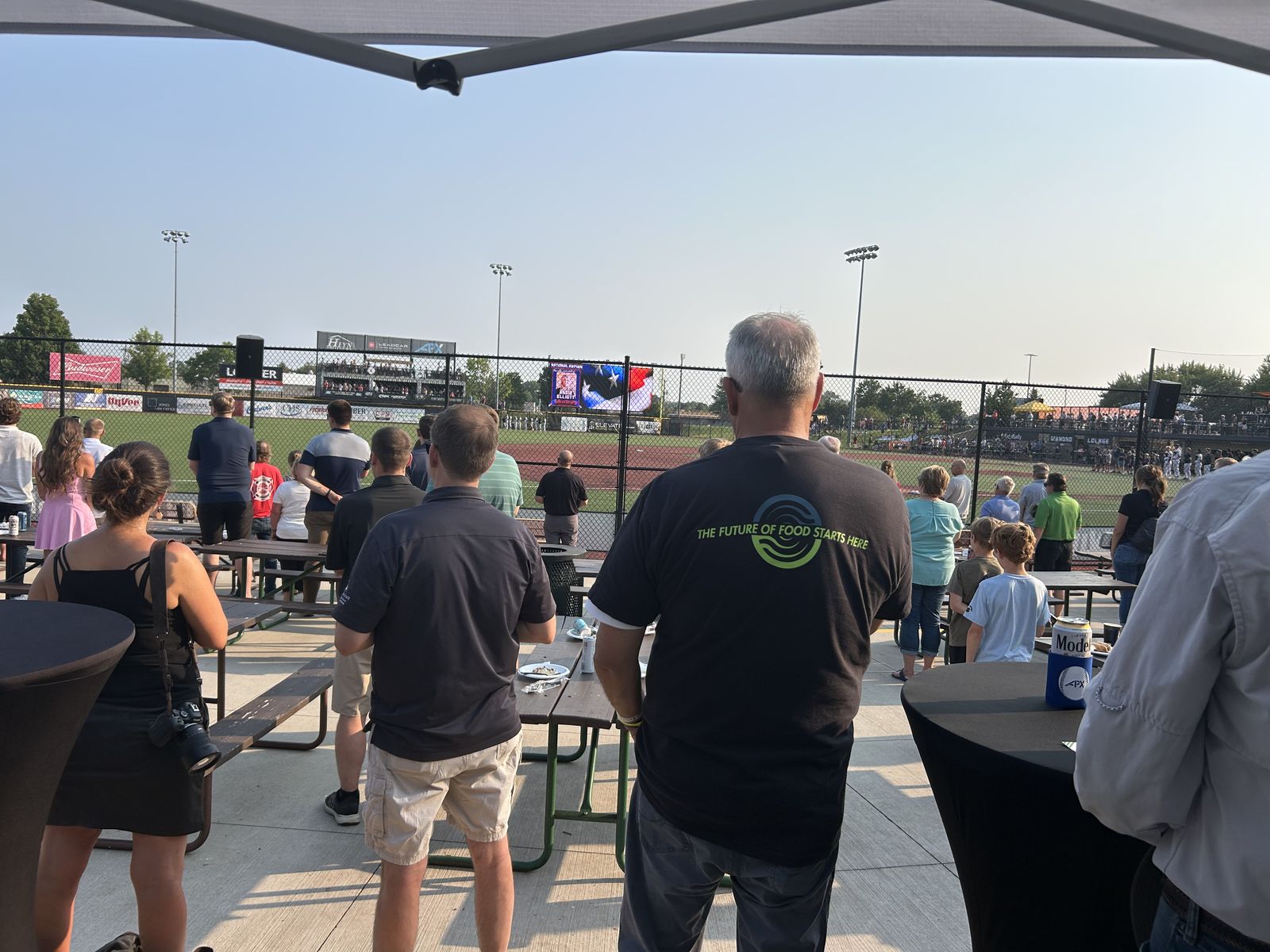 Attendees standing for the national anthem