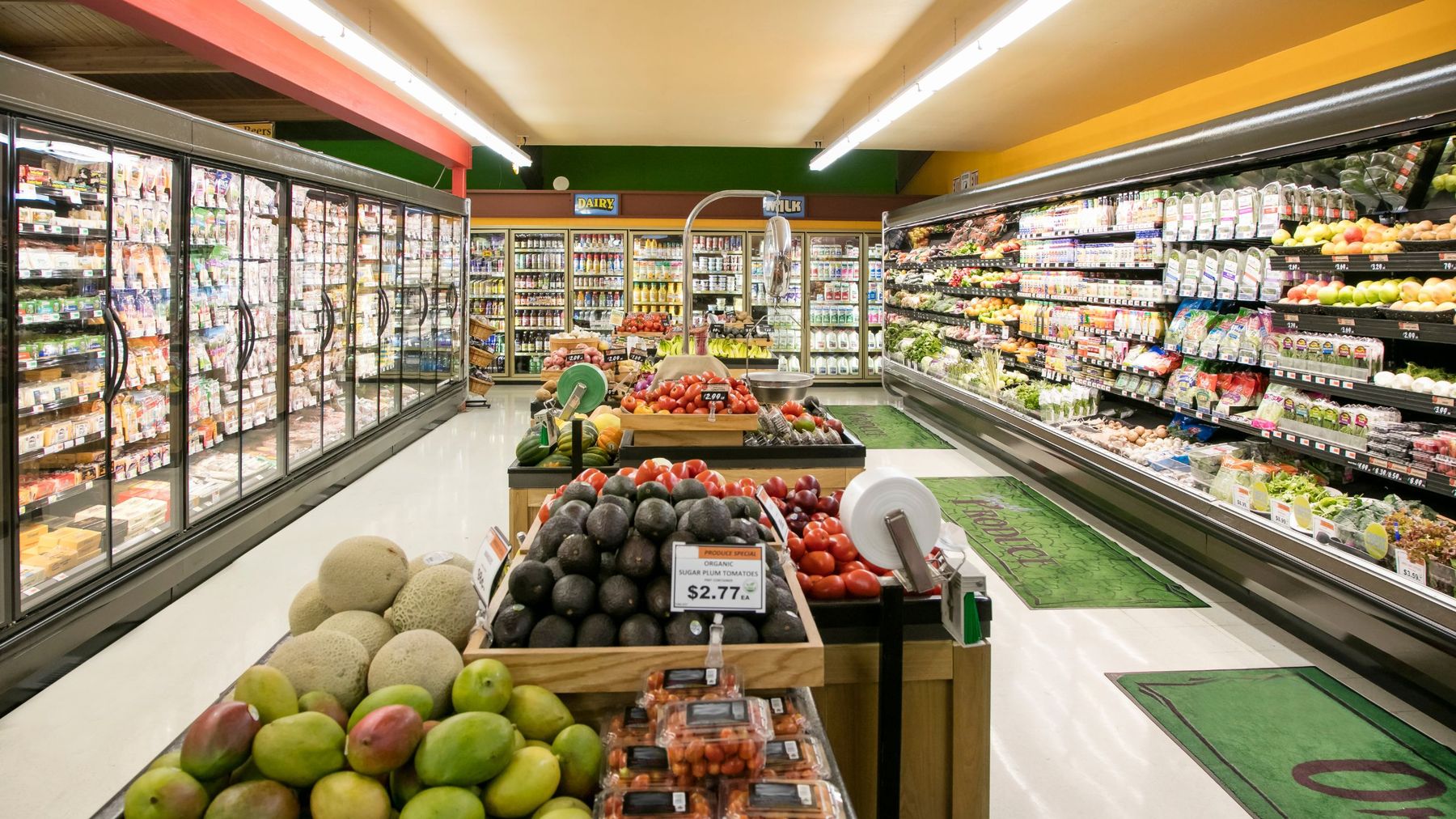 A grocery store produce section stocked with fresh fruits and vegetables